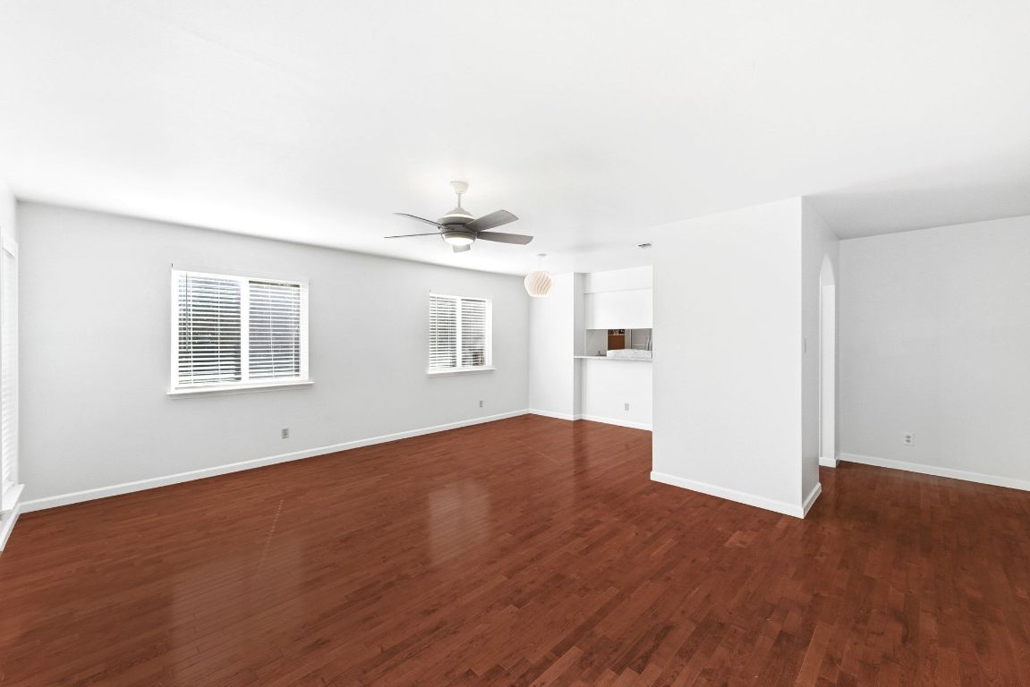 6210 Shadow Valley Drive, Unit A Austin, TX 78731 - Photo 16 of 29 Larger living room with dark wood-style flooring and a ceiling fan