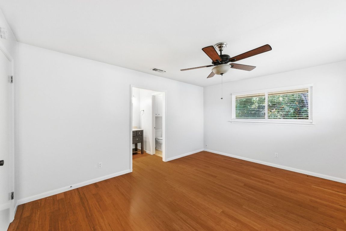 6210 Shadow Valley Drive, Unit A Austin, TX 78731 - Photo 18 of 29 Primary bedroom featuring wood finished floors and ceiling fan