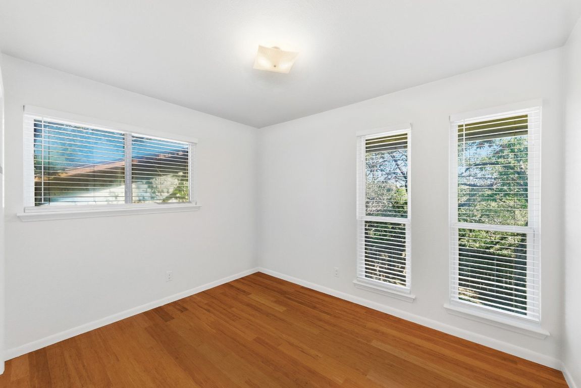 6210 Shadow Valley Drive, Unit A Austin, TX 78731 - Photo 21 of 29 Secondary bedroom featuring healthy amount of natural light and wood finished floors
