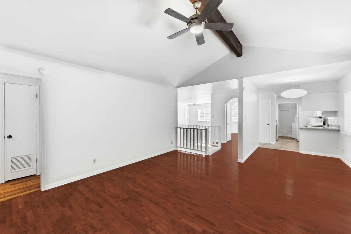 6210 Shadow Valley Drive, Unit A Austin, TX 78731 - Photo 5 of 29 One of two living rooms with dark wood-style flooring and a ceiling fan open to kitchen