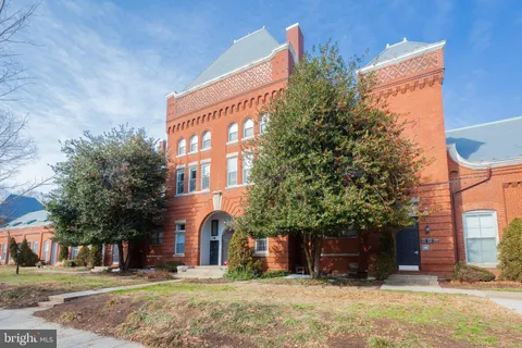 a front view of a building with a yard