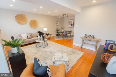 a living room with furniture and wooden floor