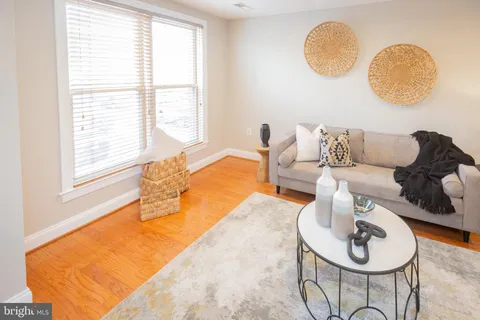 a living room with couches chairs and a large window