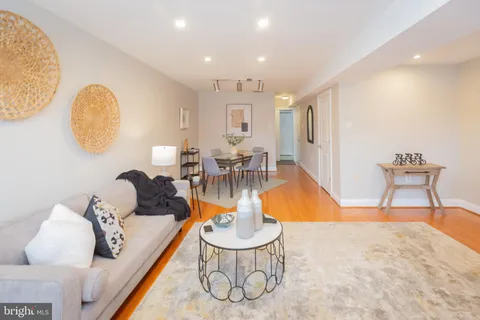 a living room with furniture a window and a table
