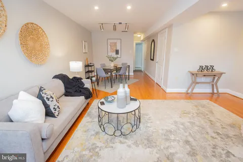 a living room with furniture and a white wall