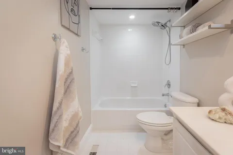 a bedroom with a bed mirror and window