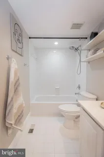 a bed room with a bed lamp and a chandelier