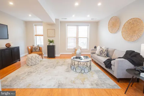 a living room with furniture rug and window