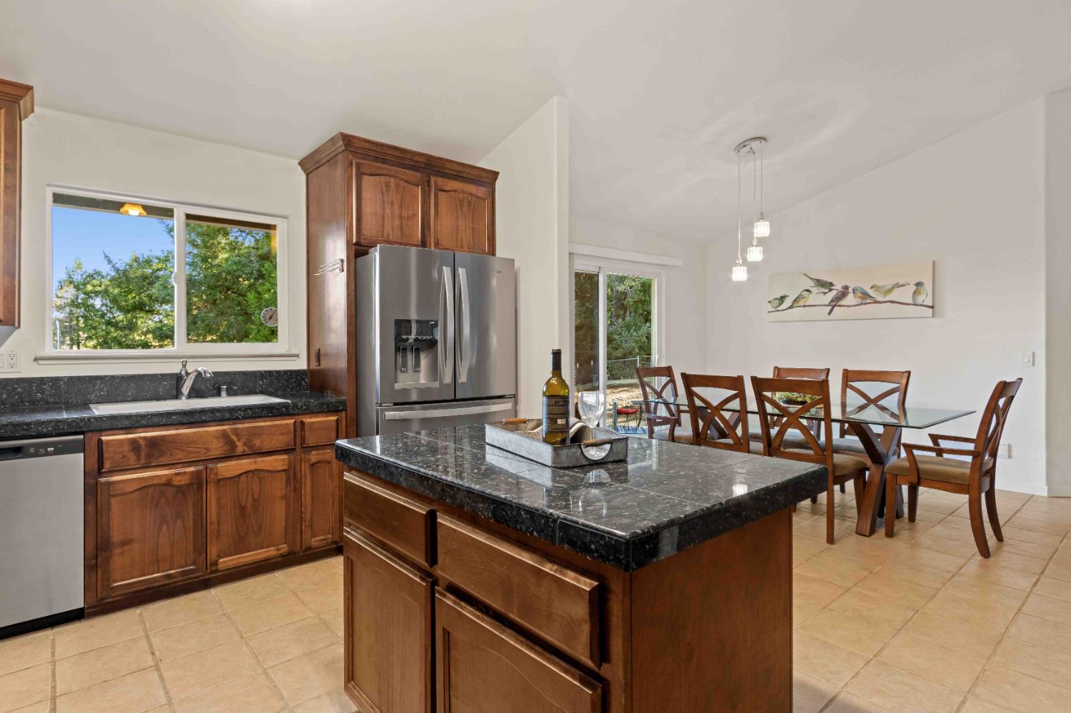 5341 Puerta Del Sol Road Camino, CA 95709 - Photo 2 of 32 a kitchen with granite countertop stainless steel appliances a table and chairs in it