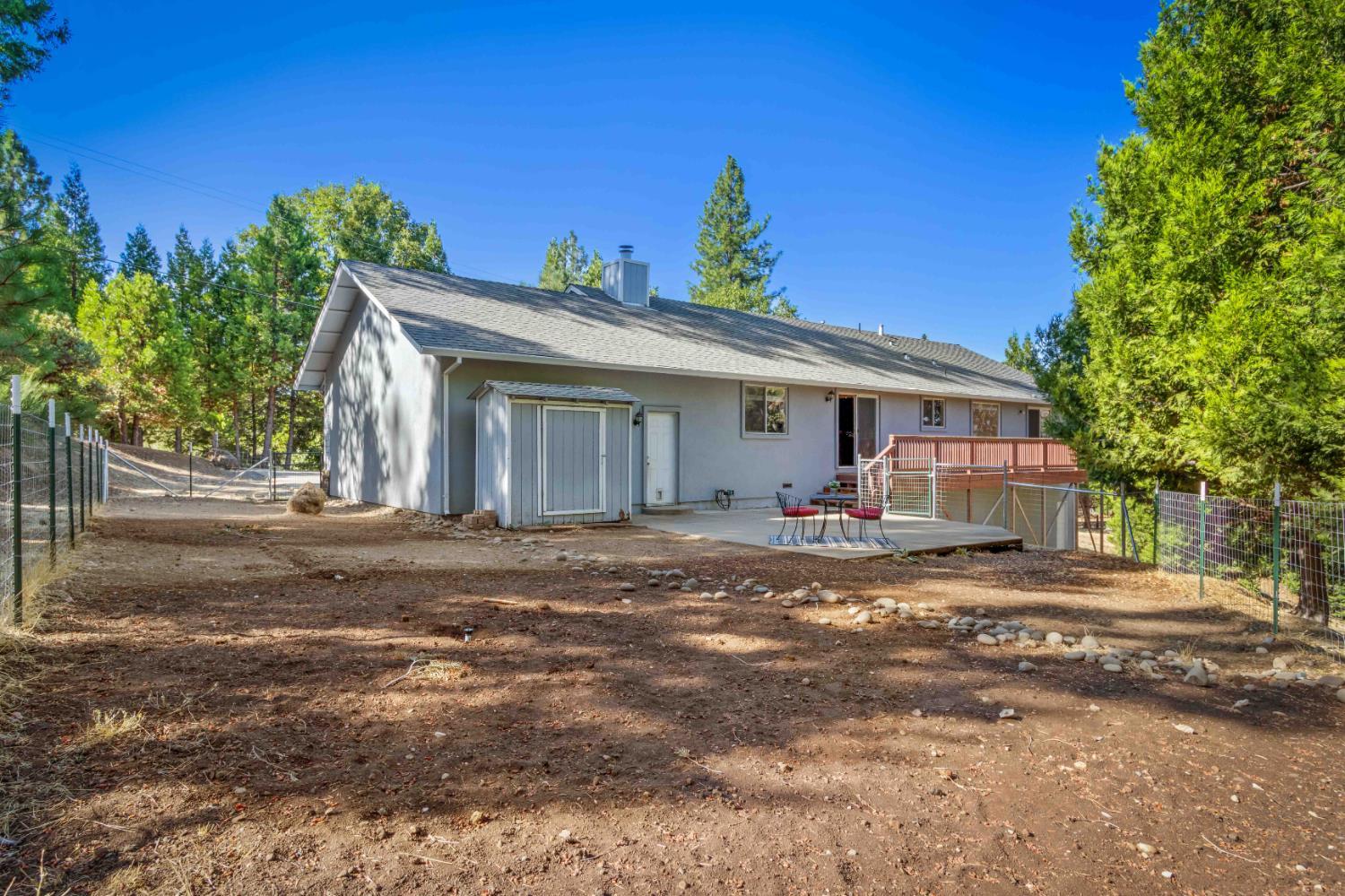 5341 Puerta Del Sol Road Camino, CA 95709 - Photo 29 of 32 a view of a house with a yard and a garage
