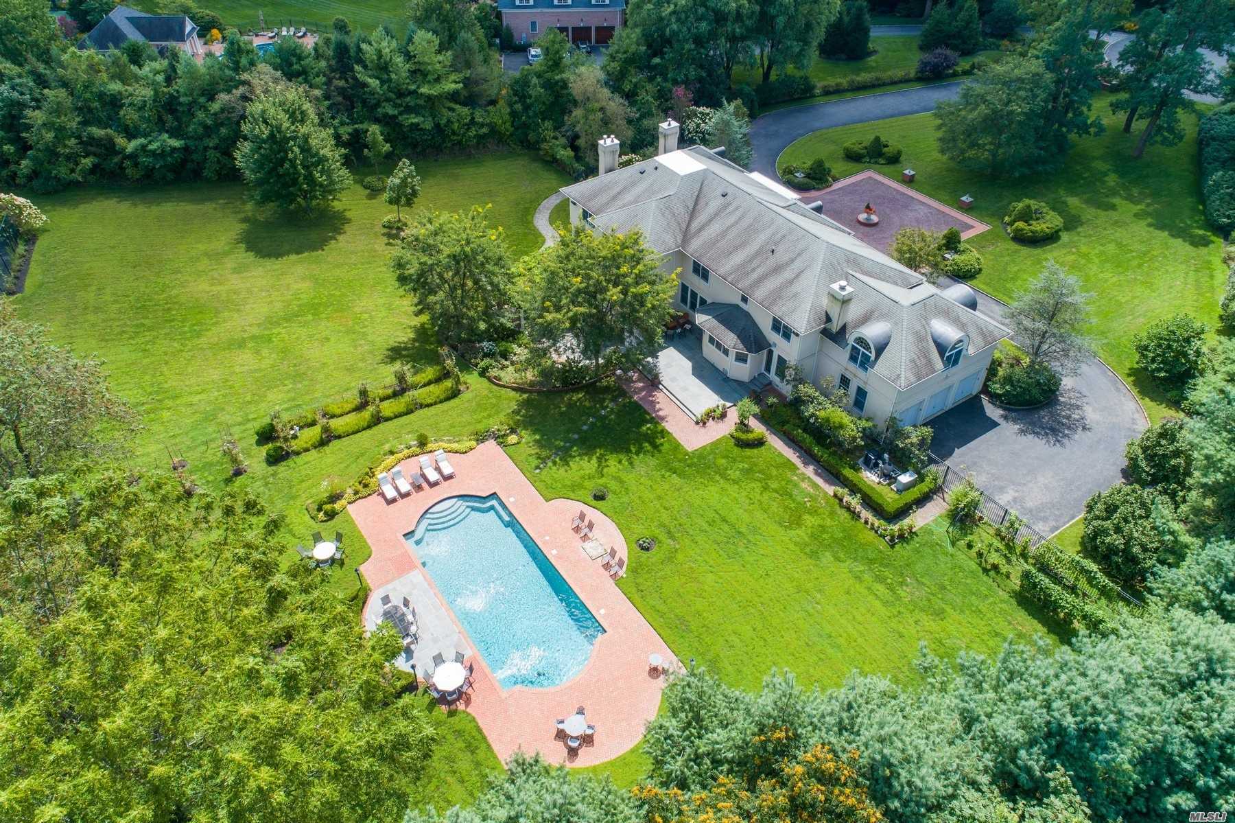 an aerial view of a house with swimming pool and outdoor space