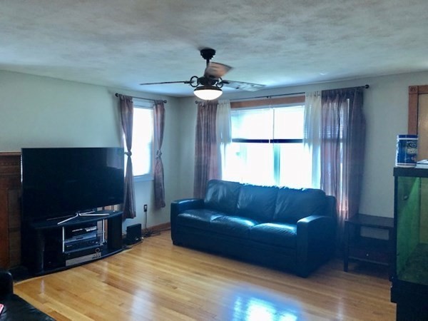 216 Mallowhill Road Springfield, MA 01129 - Photo 3 of 15 a living room with furniture and a flat screen tv