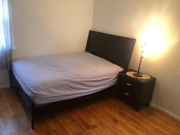 216 Mallowhill Road Springfield, MA 01129 - Photo 7 of 15 a bed sitting in a bedroom next to a window