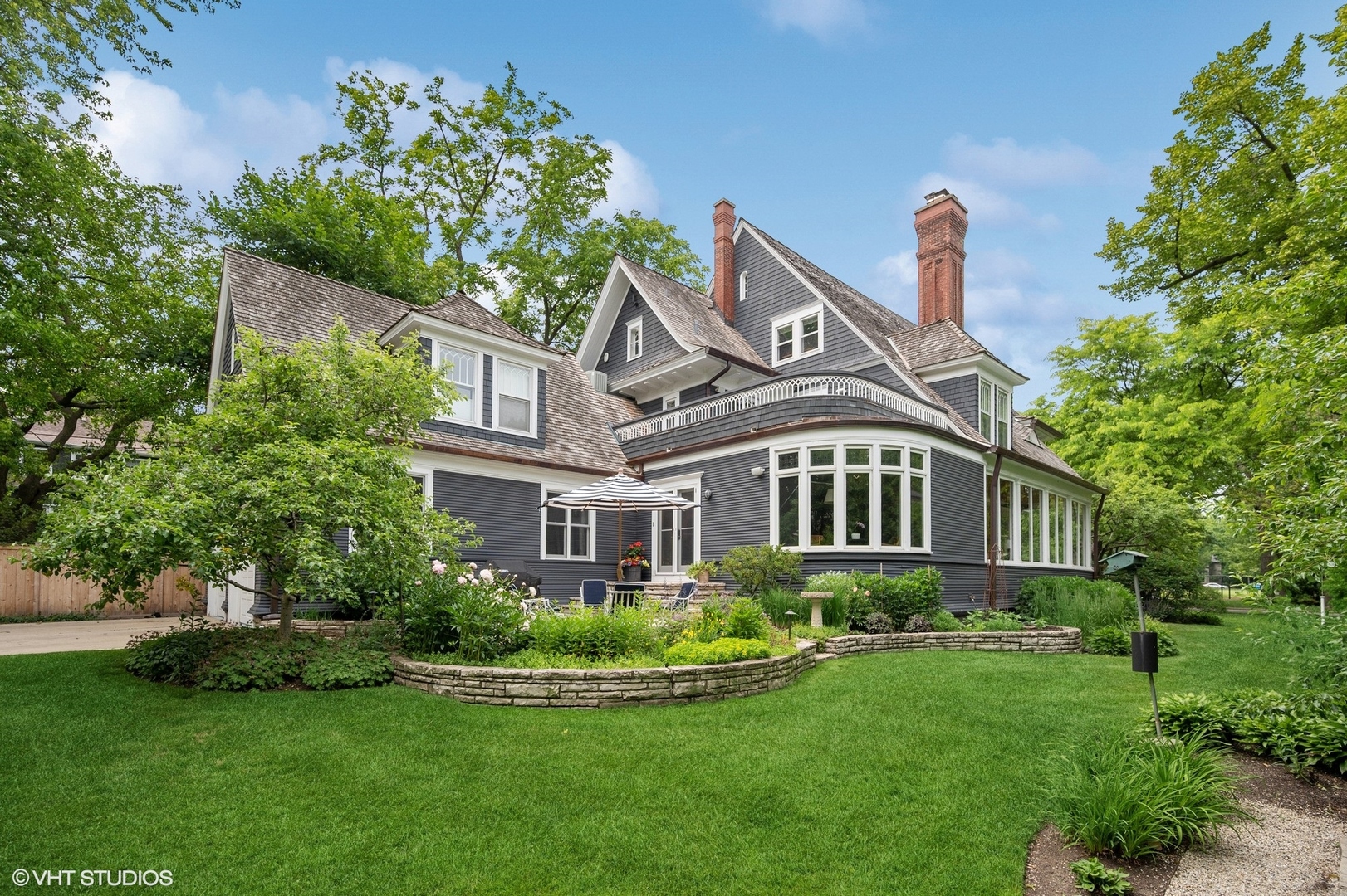 644 Oak Street Winnetka, IL 60093 - Photo 2 of 40 a front view of a house with a yard and potted plants