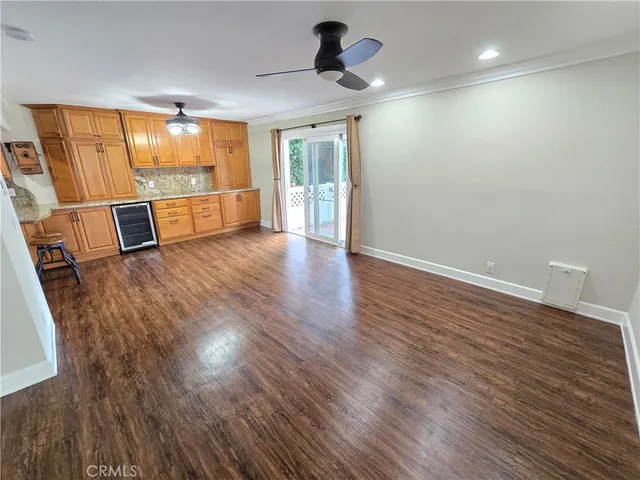 a large kitchen with stainless steel appliances granite countertop a sink dishwasher a stove with wooden floor