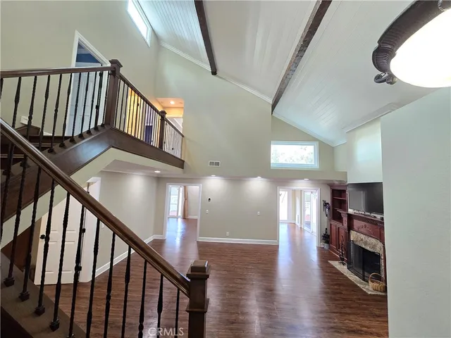 a room with wooden floor and fireplace