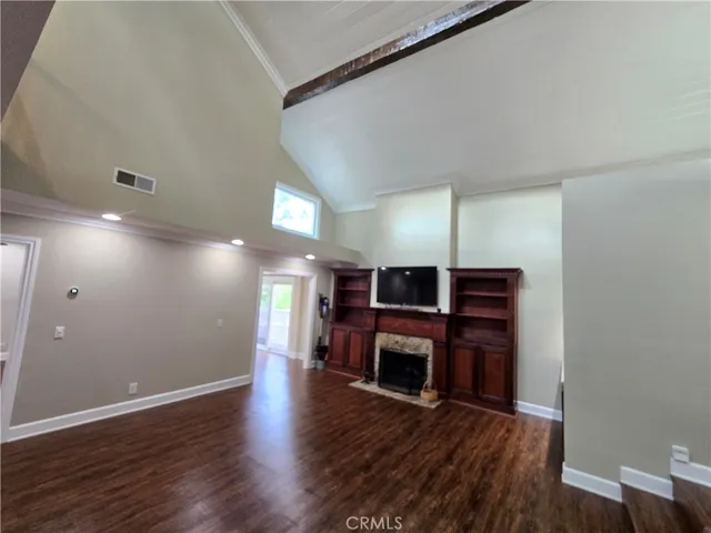 a view of living room with furniture fireplace and wooden floor