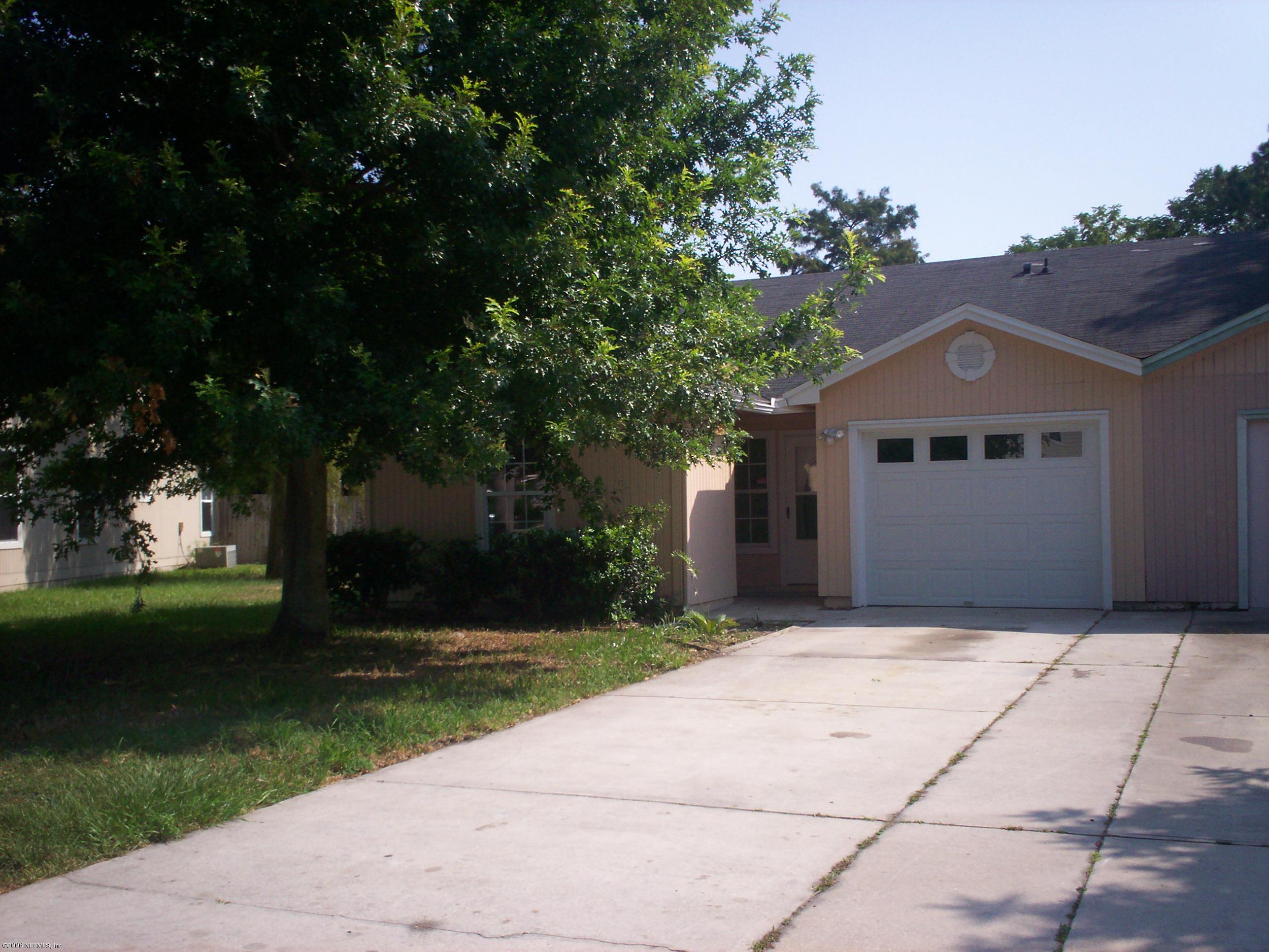 11795 Wattle Tree Road North Jacksonville, FL 32246 - Photo 1 of 8 a front view of a house with garden