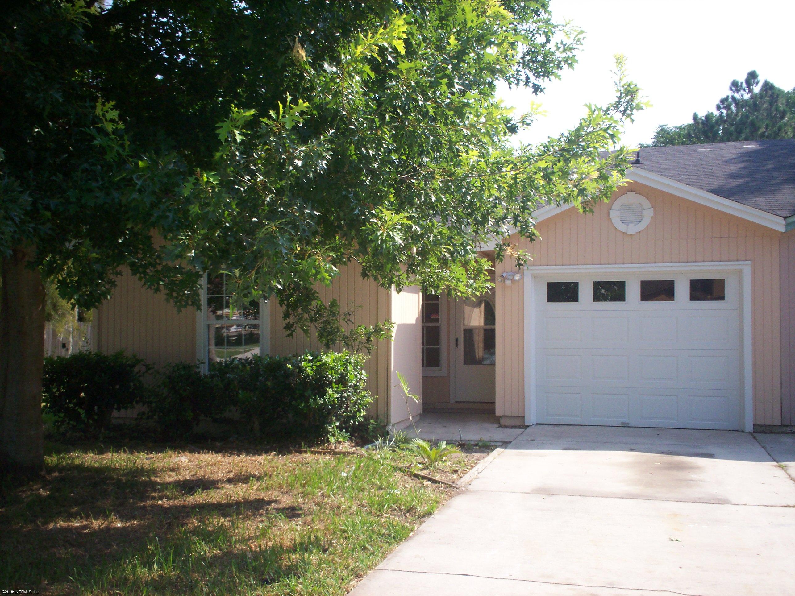 11795 Wattle Tree Road North Jacksonville, FL 32246 - Photo 2 of 8 a front view of a house with garden
