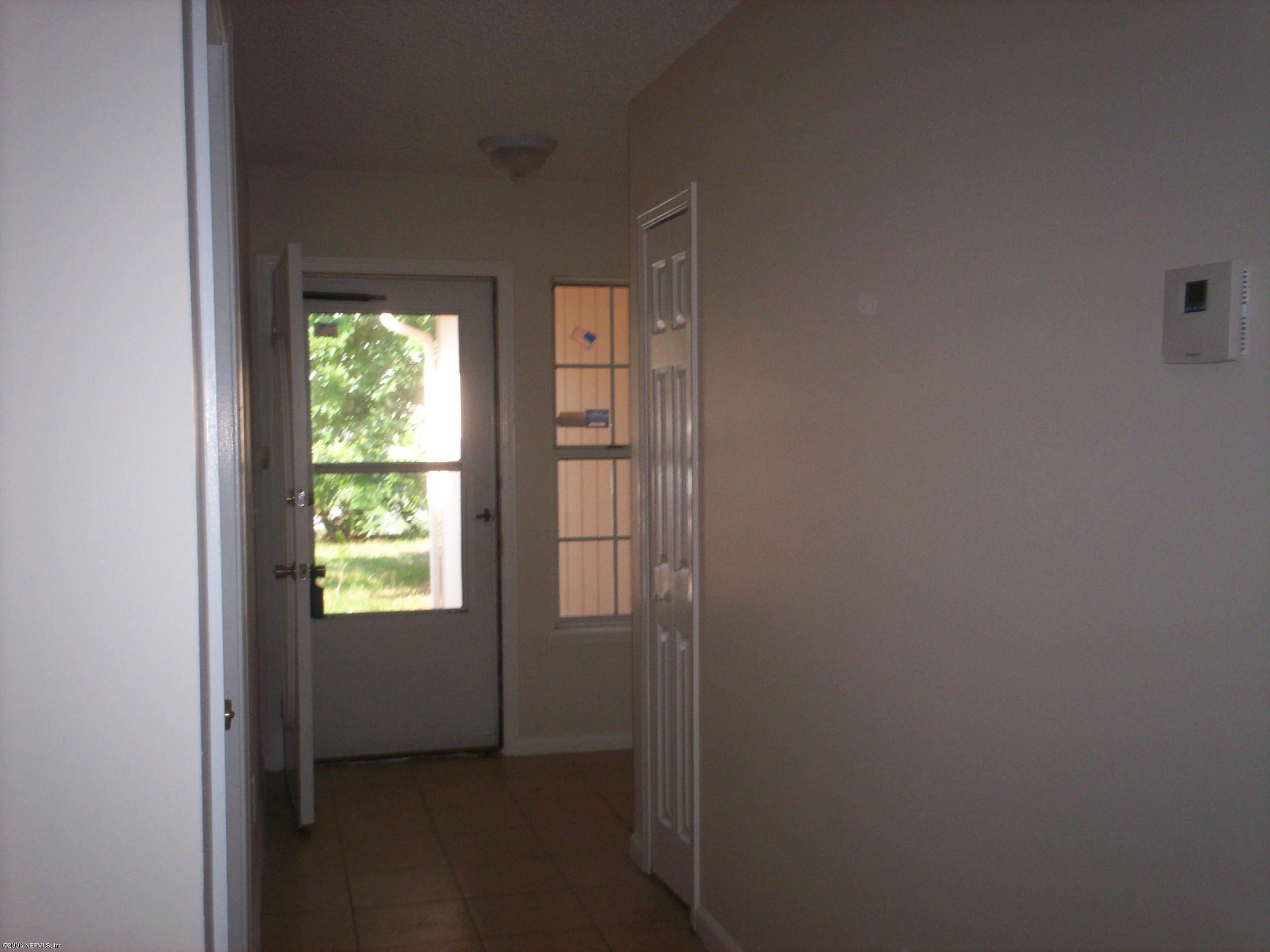11795 Wattle Tree Road North Jacksonville, FL 32246 - Photo 3 of 8 a view of an empty room and window