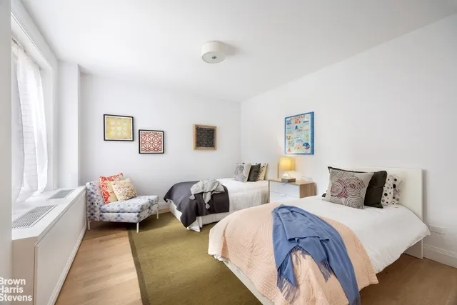 a bedroom with two beds and painted walls