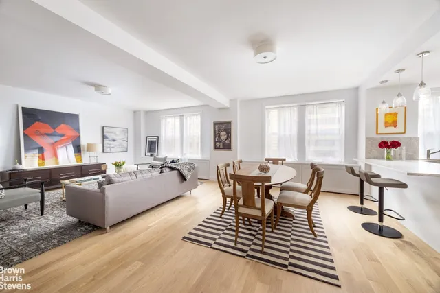 a living room with furniture and a dining table