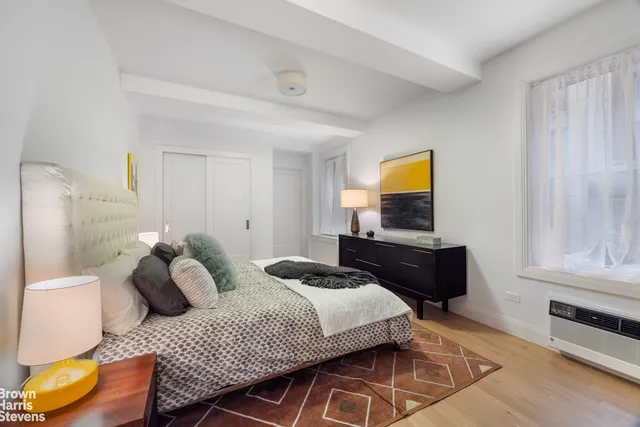 a bedroom with two beds and a window