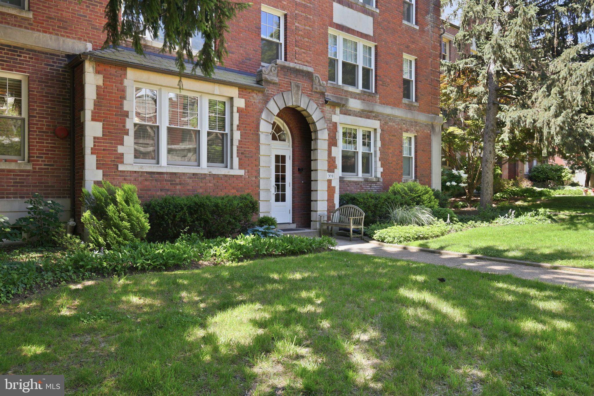 3018 Porter Street Northwest, Unit 103 Washington, DC 20008 - Photo 2 of 27 Charming brick facade with lush greenery.