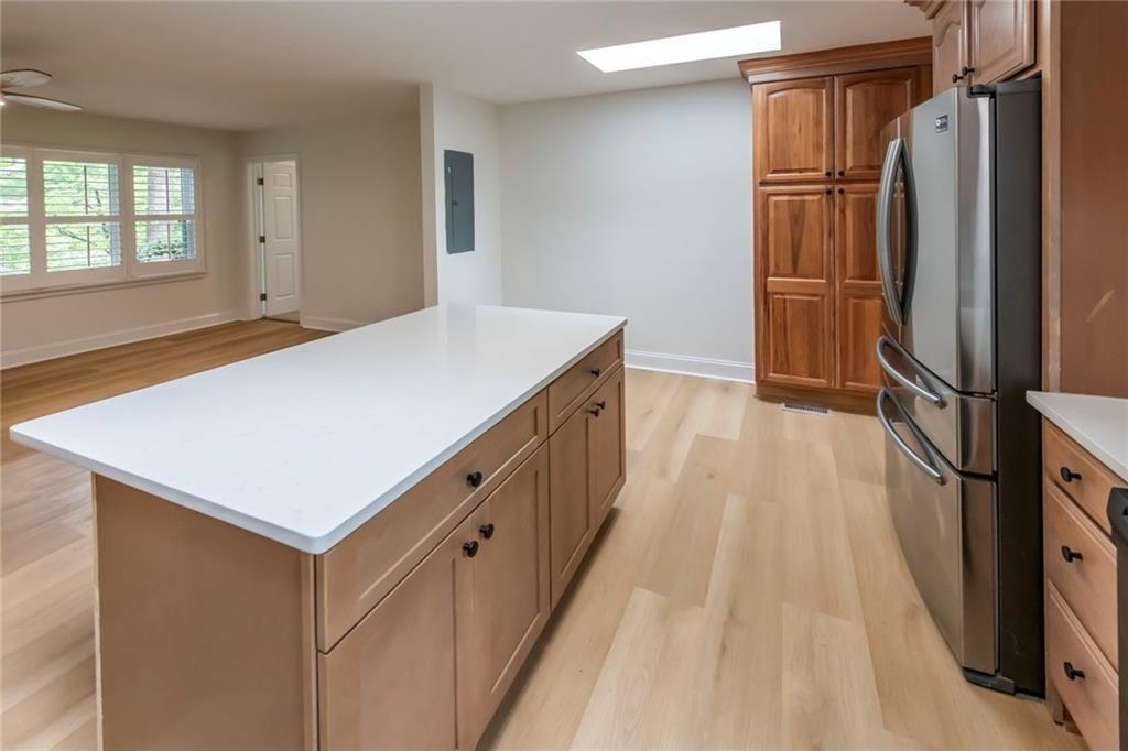 3819 Mason Creek Road Winston, GA 30187 - Photo 11 of 54 a kitchen with kitchen island a counter top space wooden floor and stainless steel appliances