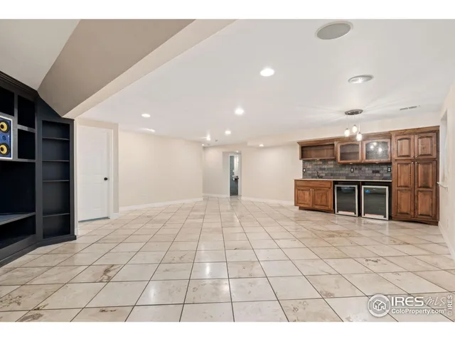 a open kitchen with stainless steel appliances a refrigerator and a stove top oven