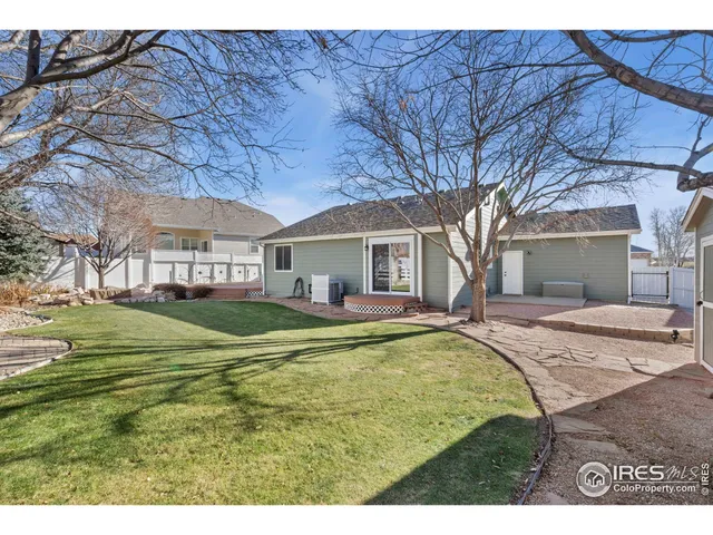 a view of a house with a swimming pool and a yard