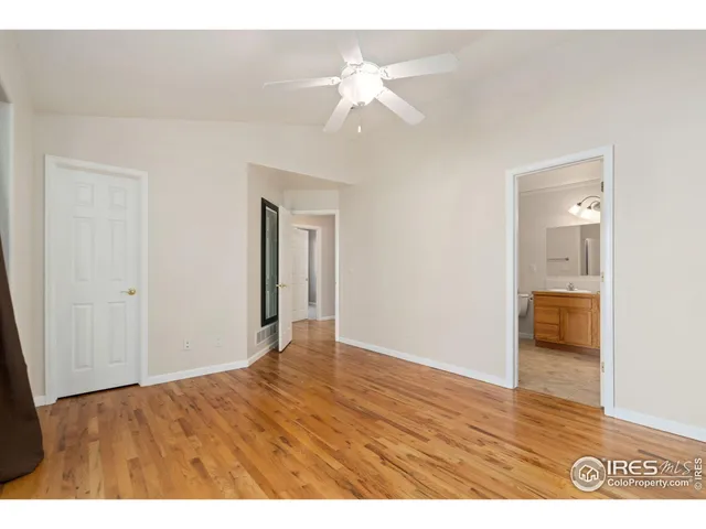 a view of an empty room and wooden floor