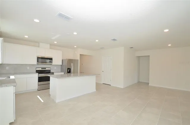 a view of an empty room and a window