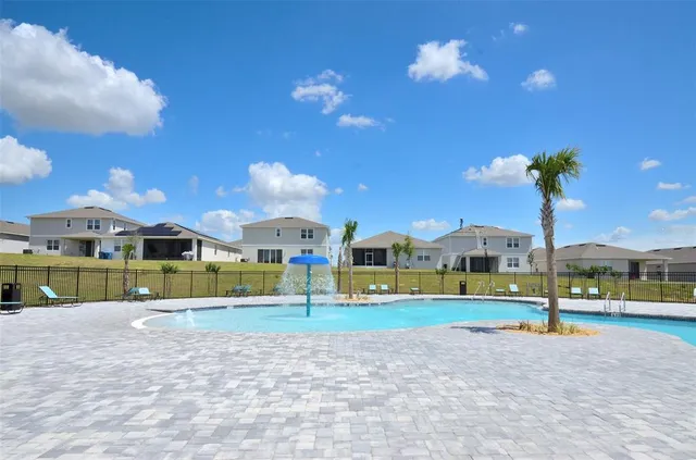 a view of outdoor space with playground and green space