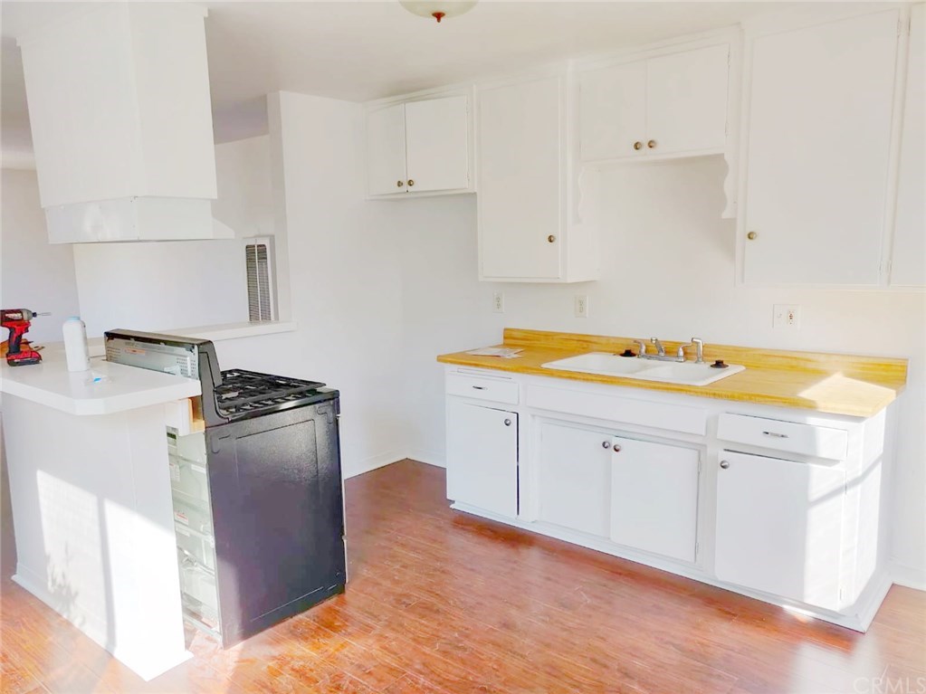 7793 15th Street Westminster, CA 92683 - Photo 5 of 11 a kitchen with a refrigerator and cabinets