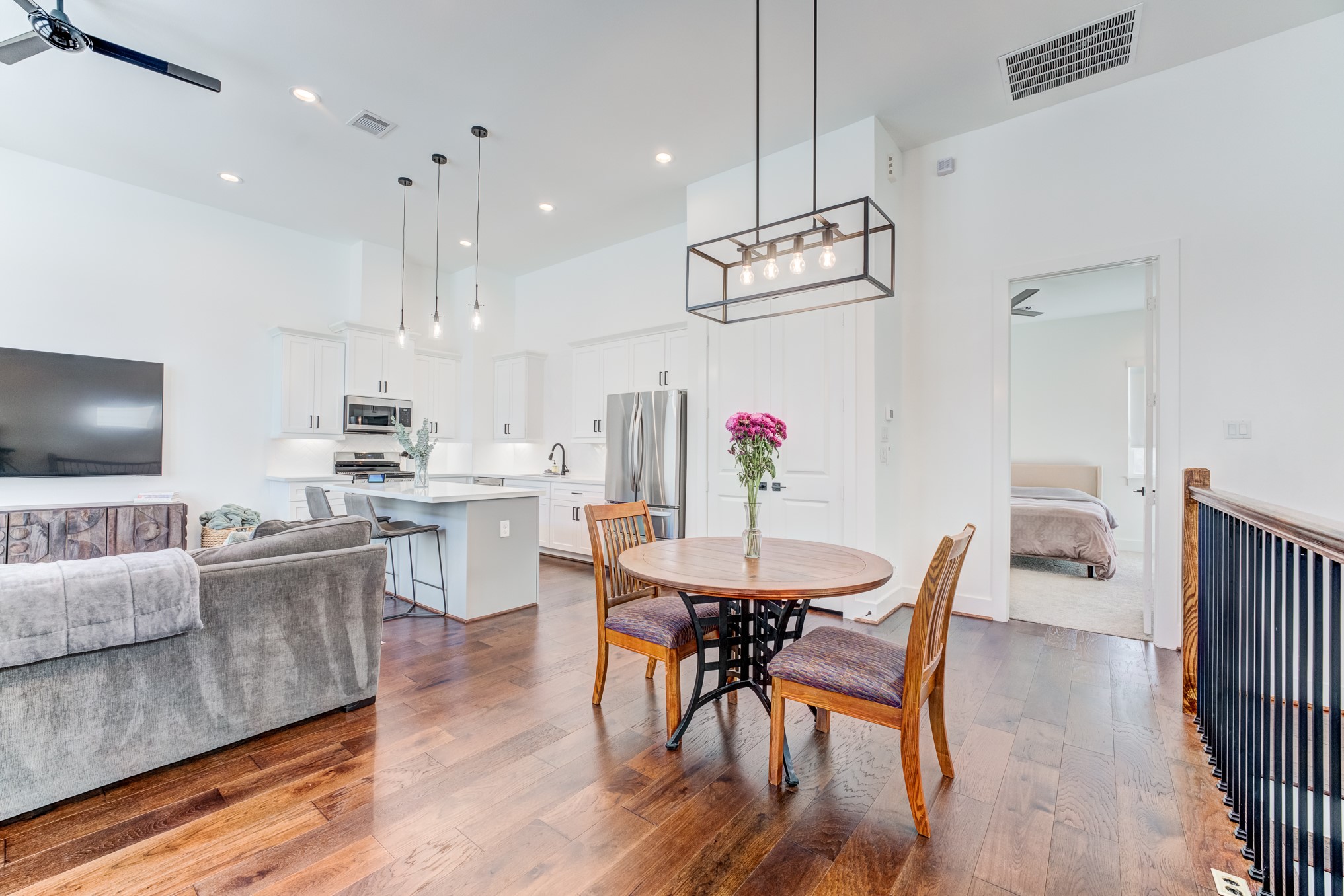 107 West Whitney Street, Unit E Houston, TX 77018 - Photo 19 of 48 a view of a dining room with furniture wooden floor and chandelier