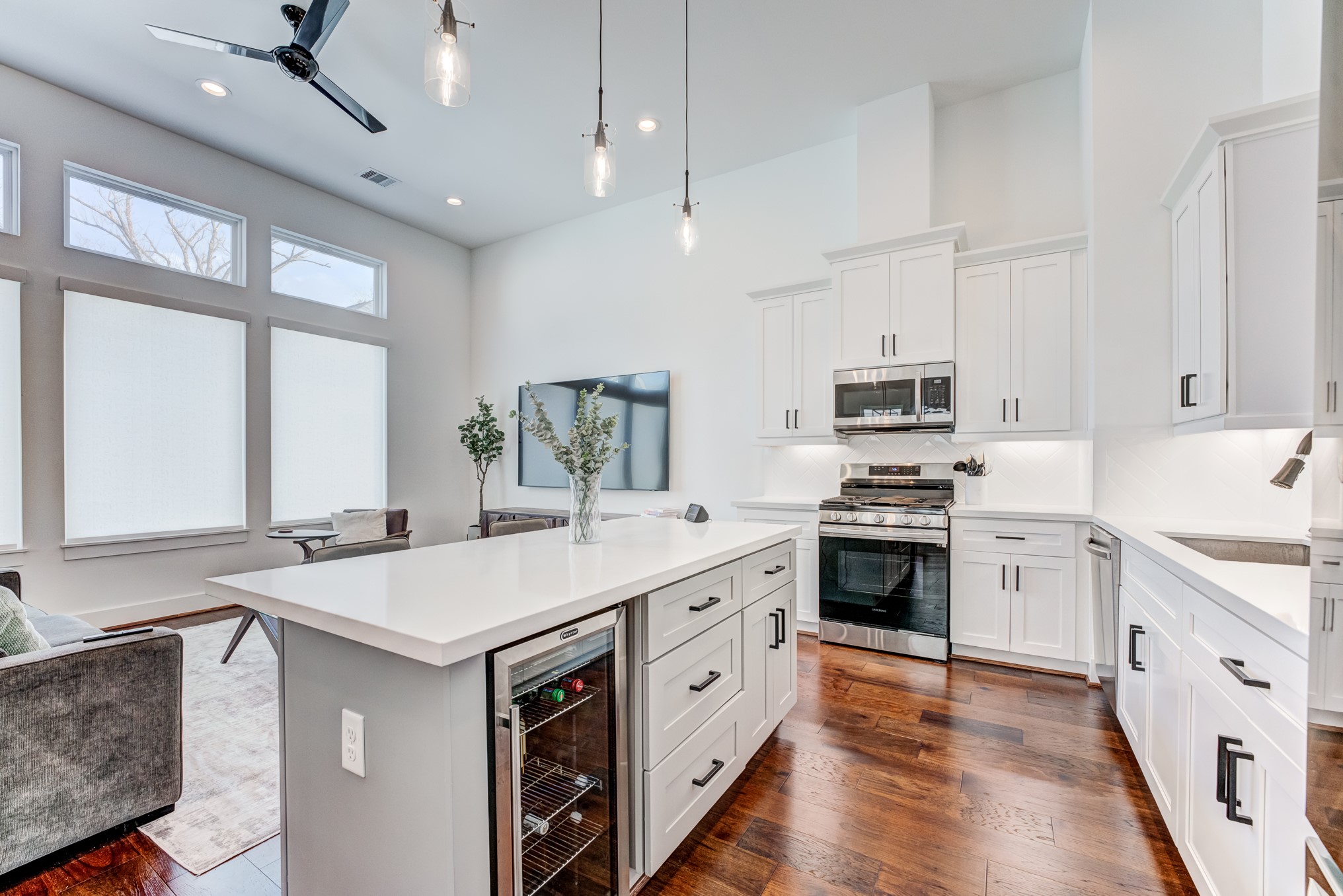 107 West Whitney Street, Unit E Houston, TX 77018 - Photo 21 of 48 a kitchen with stainless steel appliances white cabinets and wooden floors