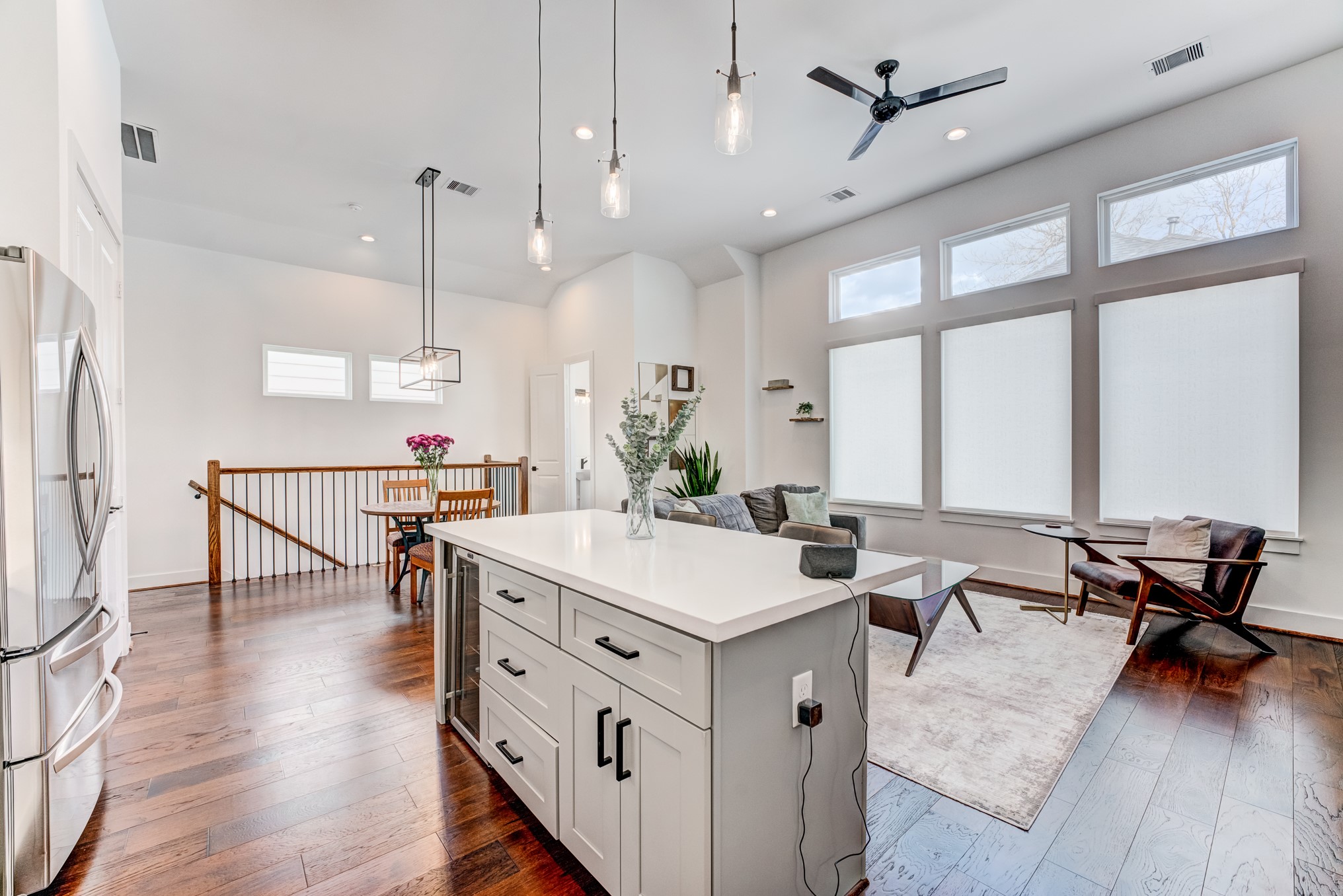 107 West Whitney Street, Unit E Houston, TX 77018 - Photo 27 of 48 a open kitchen with a table chairs stove and wooden floor
