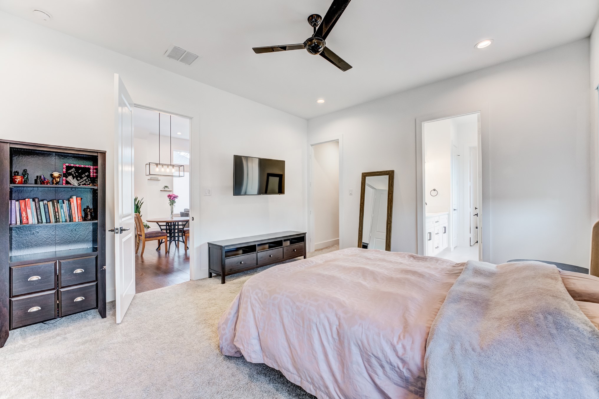 107 West Whitney Street, Unit E Houston, TX 77018 - Photo 29 of 48 a bedroom with a bed a dresser and book shelf