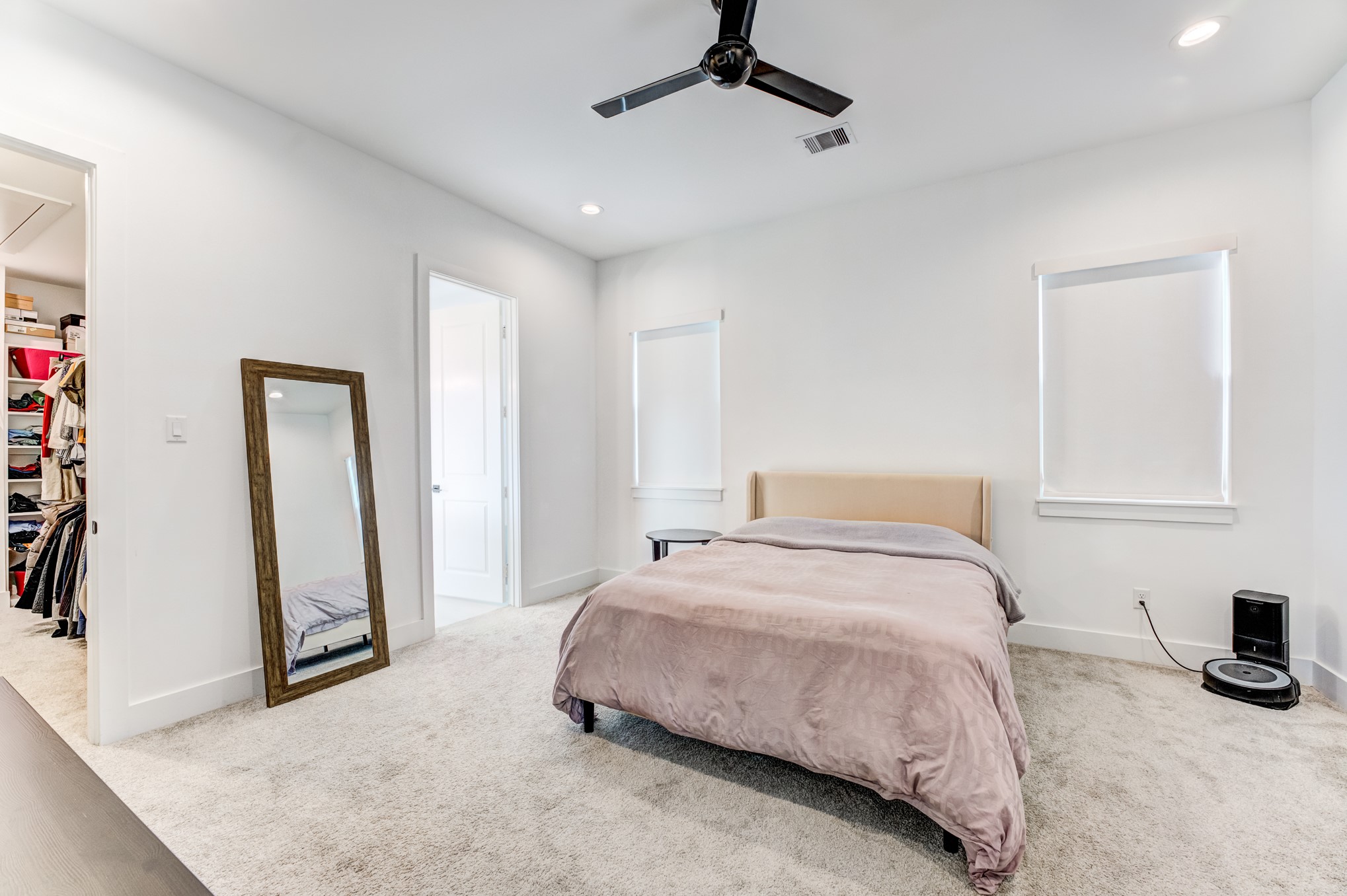 107 West Whitney Street, Unit E Houston, TX 77018 - Photo 32 of 48 a bedroom with a bed and a mirror