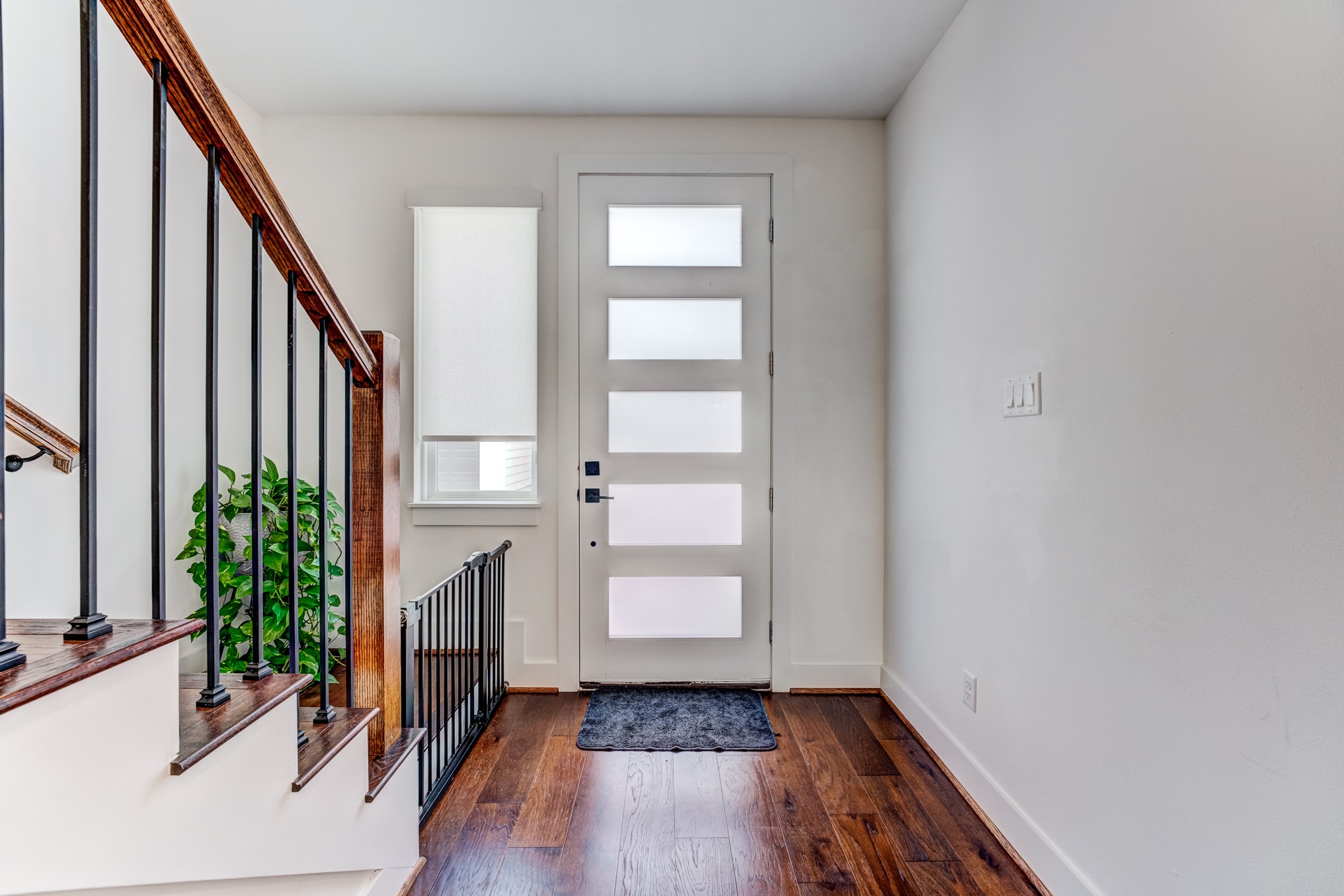 107 West Whitney Street, Unit E Houston, TX 77018 - Photo 8 of 48 a view of entryway with wooden floor and stairs
