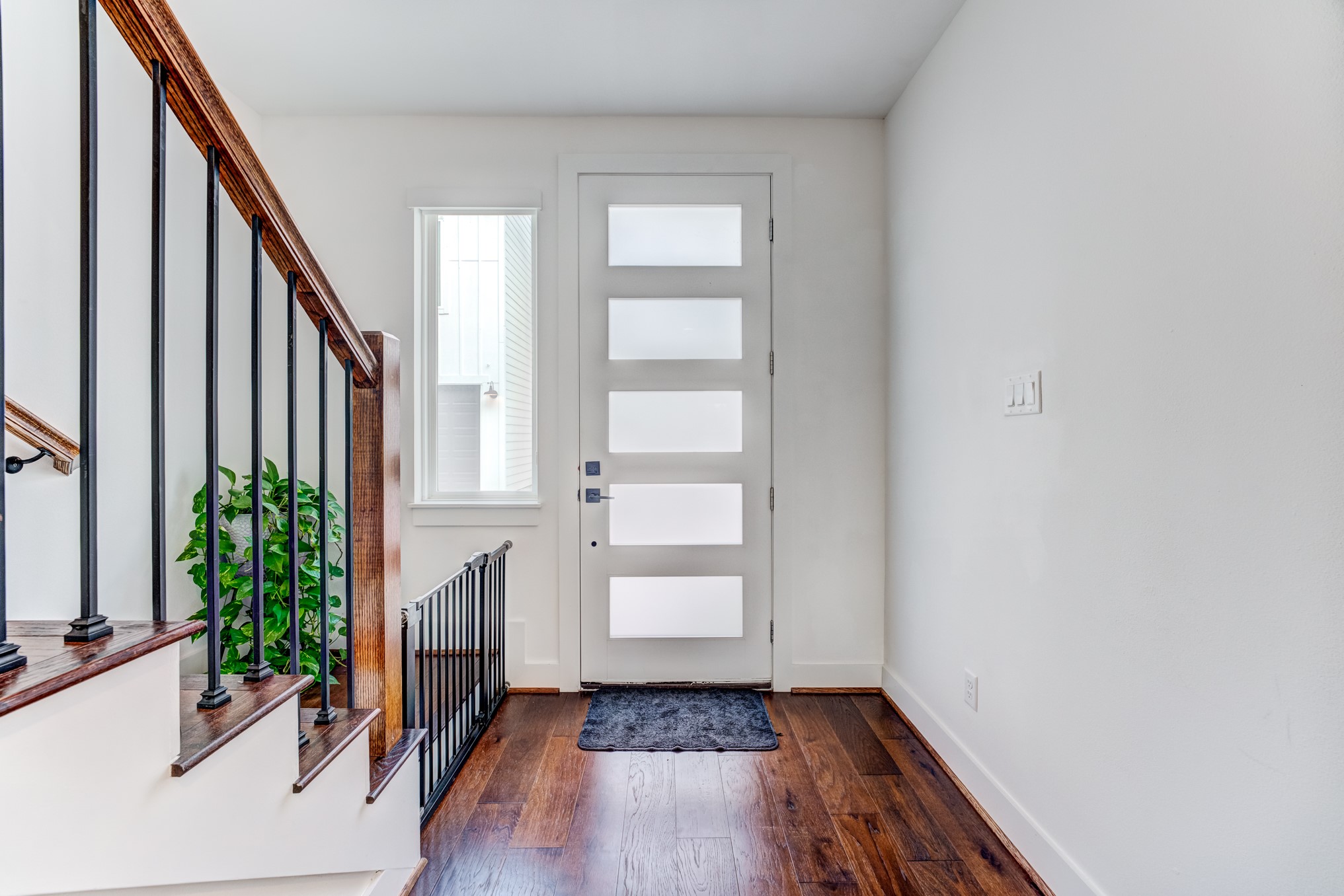 107 West Whitney Street, Unit E Houston, TX 77018 - Photo 9 of 48 a view of entryway with wooden floor and stairs