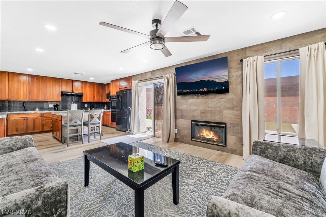 104 Appian Way Henderson, NV 89002 - Photo 8 of 24 An open concept living area blends a modern kitchen with a cozy fireplace and abundant natural light.