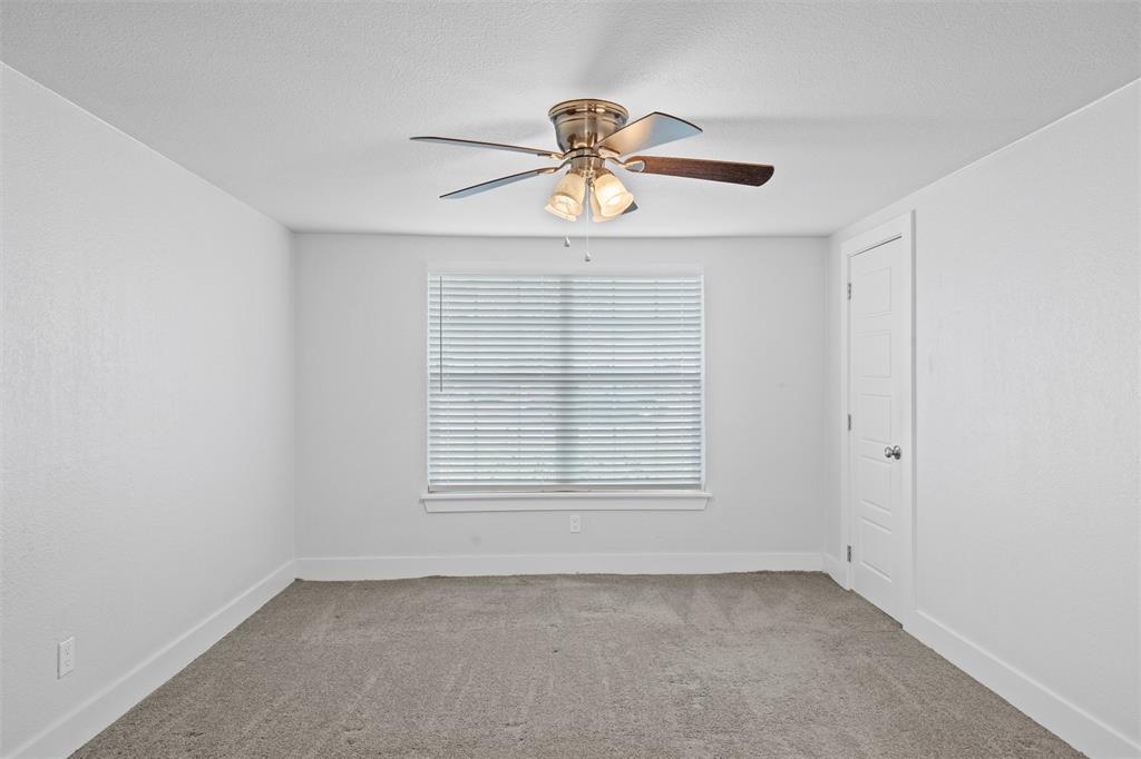 3514 Larry Street Rowlett, TX 75088 - Photo 15 of 27 an empty room with windows and fan