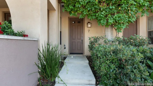 an entryway with flower plants