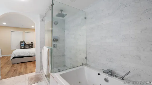 a bathroom with a tub and a shower