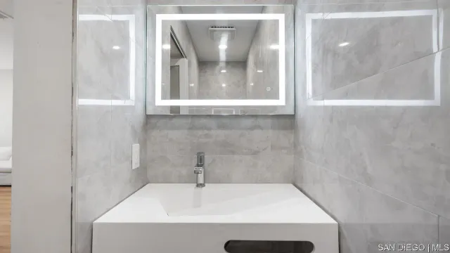 a bathroom with a sink and a mirror