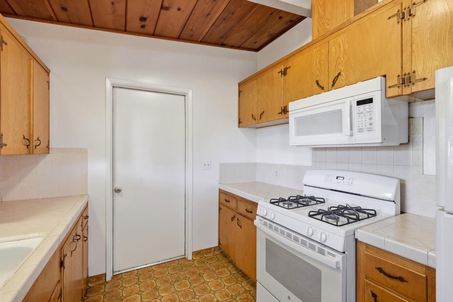 215 Manfre Road Watsonville, CA 95076 - Photo 11 of 36 a kitchen with a stove and a refrigerator
