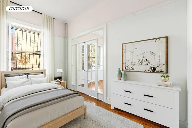 a spacious bedroom with a bed and a window