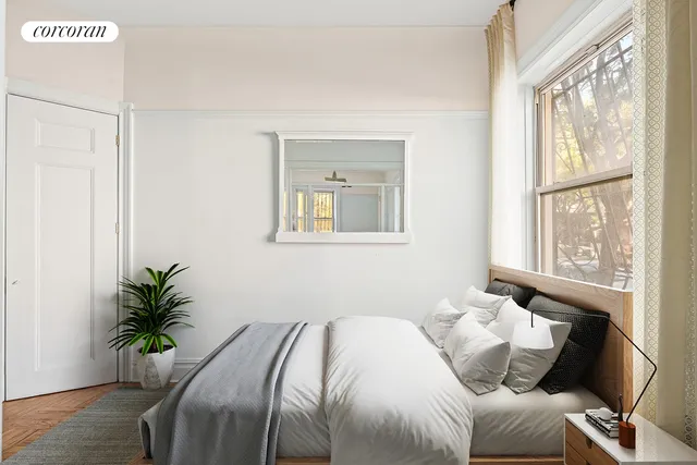 a bedroom with a bed and a window